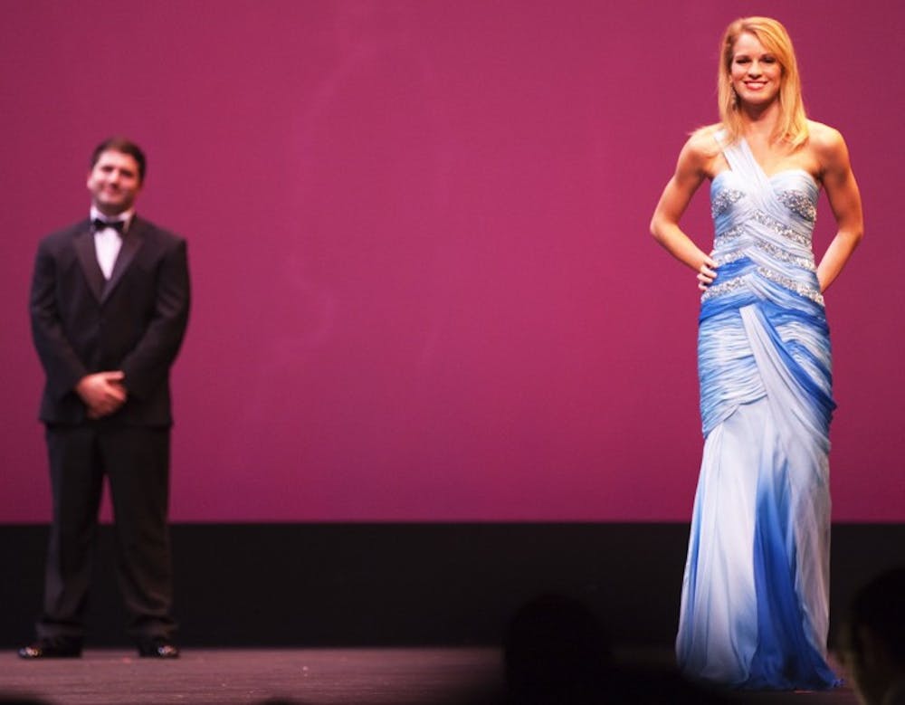 <p>Homecoming finalist contestants Andy Schein, 21, and Cecelia Hardwick, 21, smile at the crowd at the UF Homecoming Pageant 2012 at the Phillips Center for the Performing Arts on Monday night.</p>