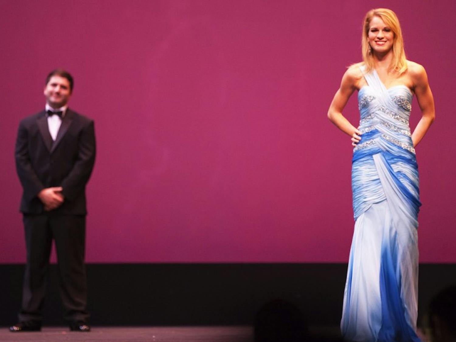 Homecoming finalist contestants Andy Schein, 21, and Cecelia Hardwick, 21, smile at the crowd at the UF Homecoming Pageant 2012 at the Phillips Center for the Performing Arts on Monday night.