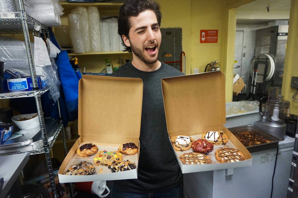 Daniel Leal, a 22-year-old UF sustainability studies senior and founder of cookie-delivery company Cookiegazm, poses with a batch of his cookies in October 2016. The late-night cookie delivery business announced it was closing on Facebook. 