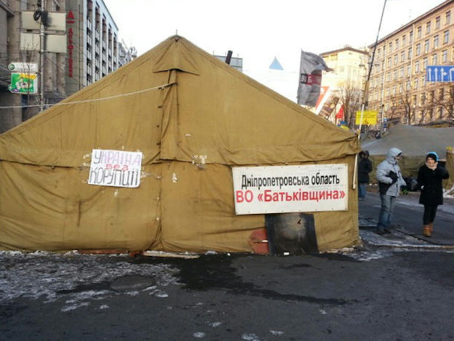 A tent sits in a street displaying signs reading “Ukraine Without Corruption.” The Ukrainian people are protesting after the local government refused to join the European Union. Three people have died, and the prime minister, Mykola Azarov, resigned on Tuesday.
