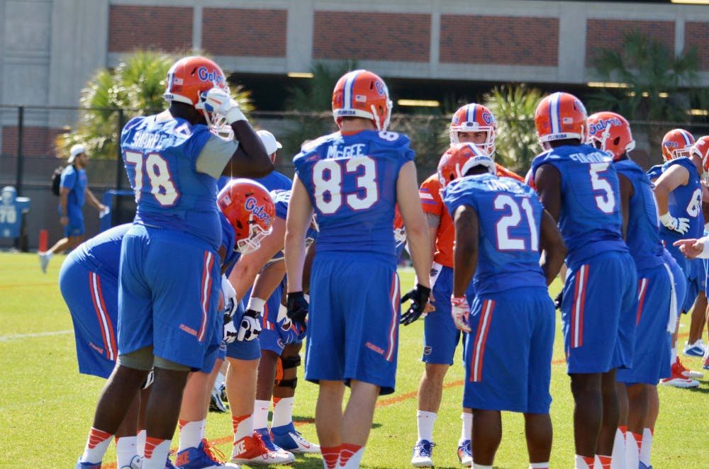 Florida players huddle during their first spring practice on Monday.