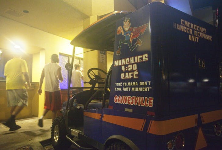 Students stroll in front of Fat Daddy’s, a new bar in Midtown, on Tuesday night. The bar, which is run by the owner of Munchies 420 Cafe, will have its grand opening Friday.