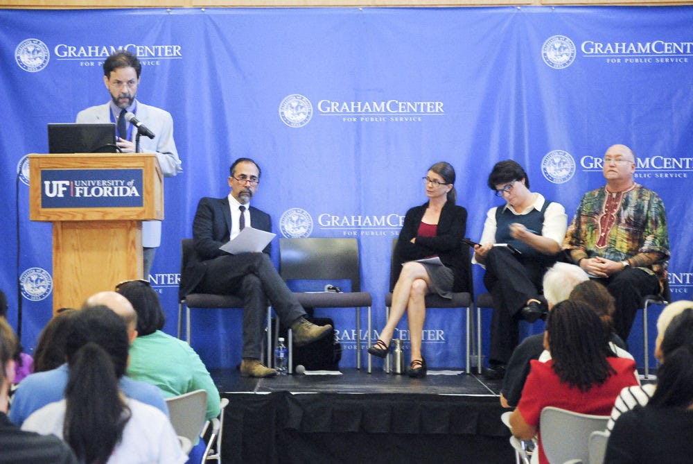 Paul Psychas, a UF community health and family medicine associate professor, speaks at the West African Ebola Epidemic discussion in Pugh Hall on Wednesday evening.