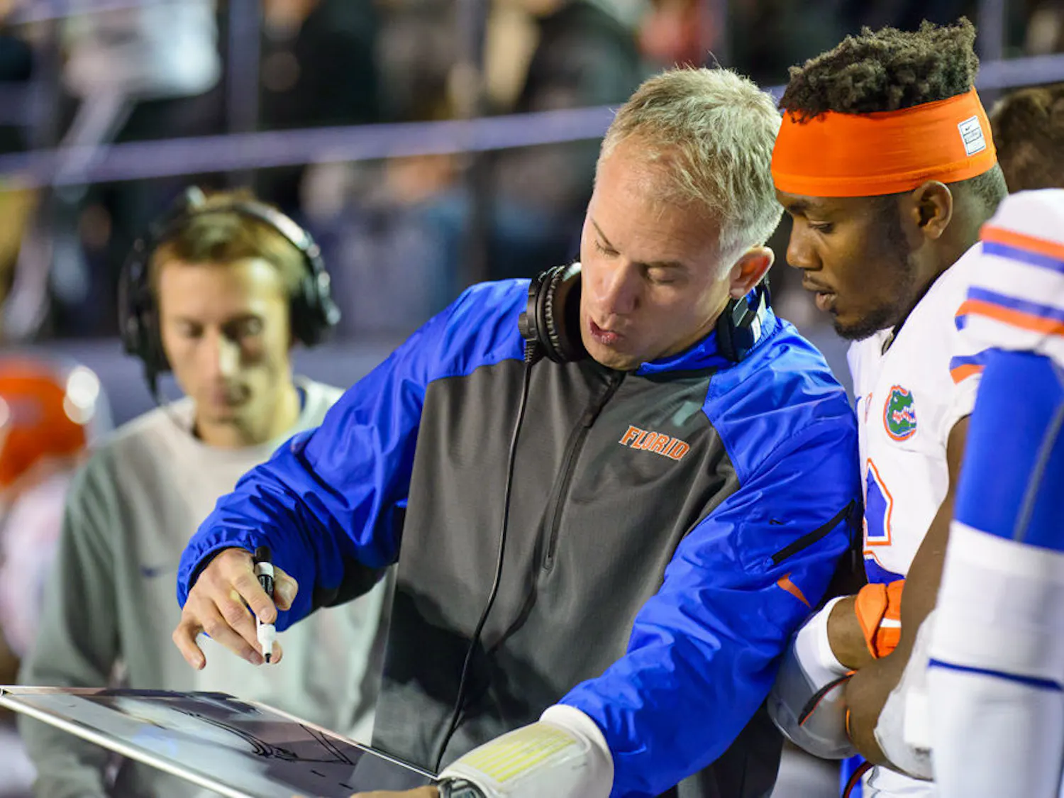 Florida defensive coordinator D. J. Durkin draws up a play for Buck linebacker Dante Fowler Jr. during Florida's win against Vanderbilt.