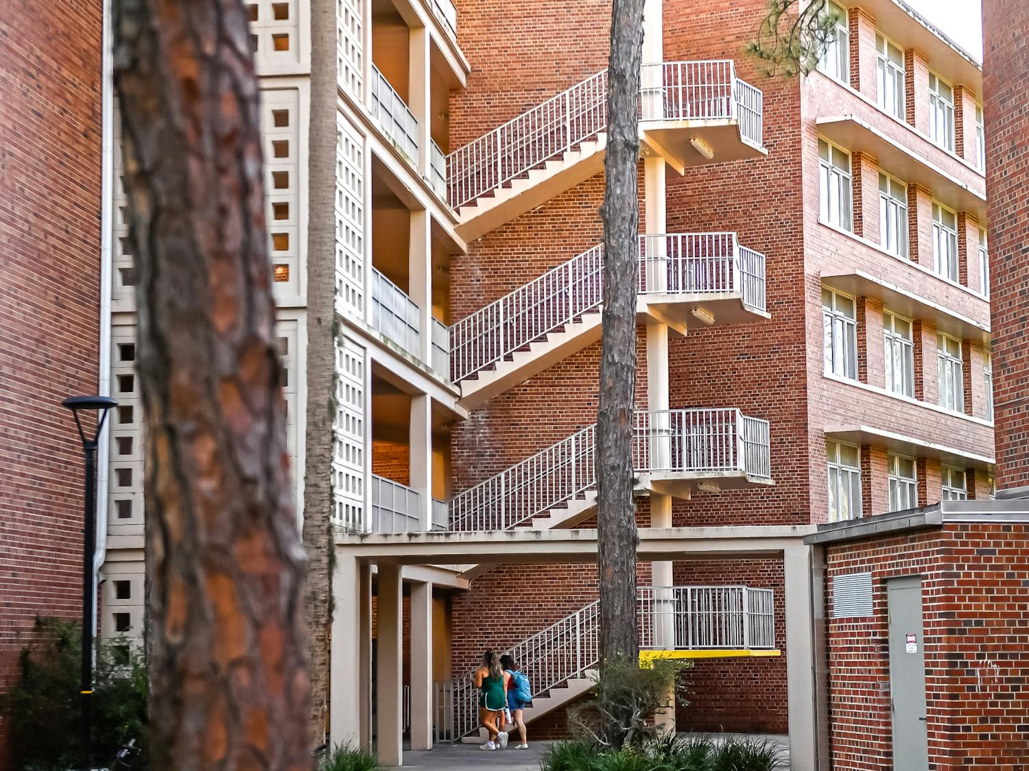 Students go to climb the stairs on Thursday, April 2, 2025, at Graham Hall in Gainesville, Florida. (Matthew Lewis)
