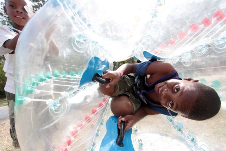 Brothers Murdolph Jones, 7, and Malaqhi Jones, 5, play in bumper balls at the Gainesville Community Fest on Saturday afternoon.