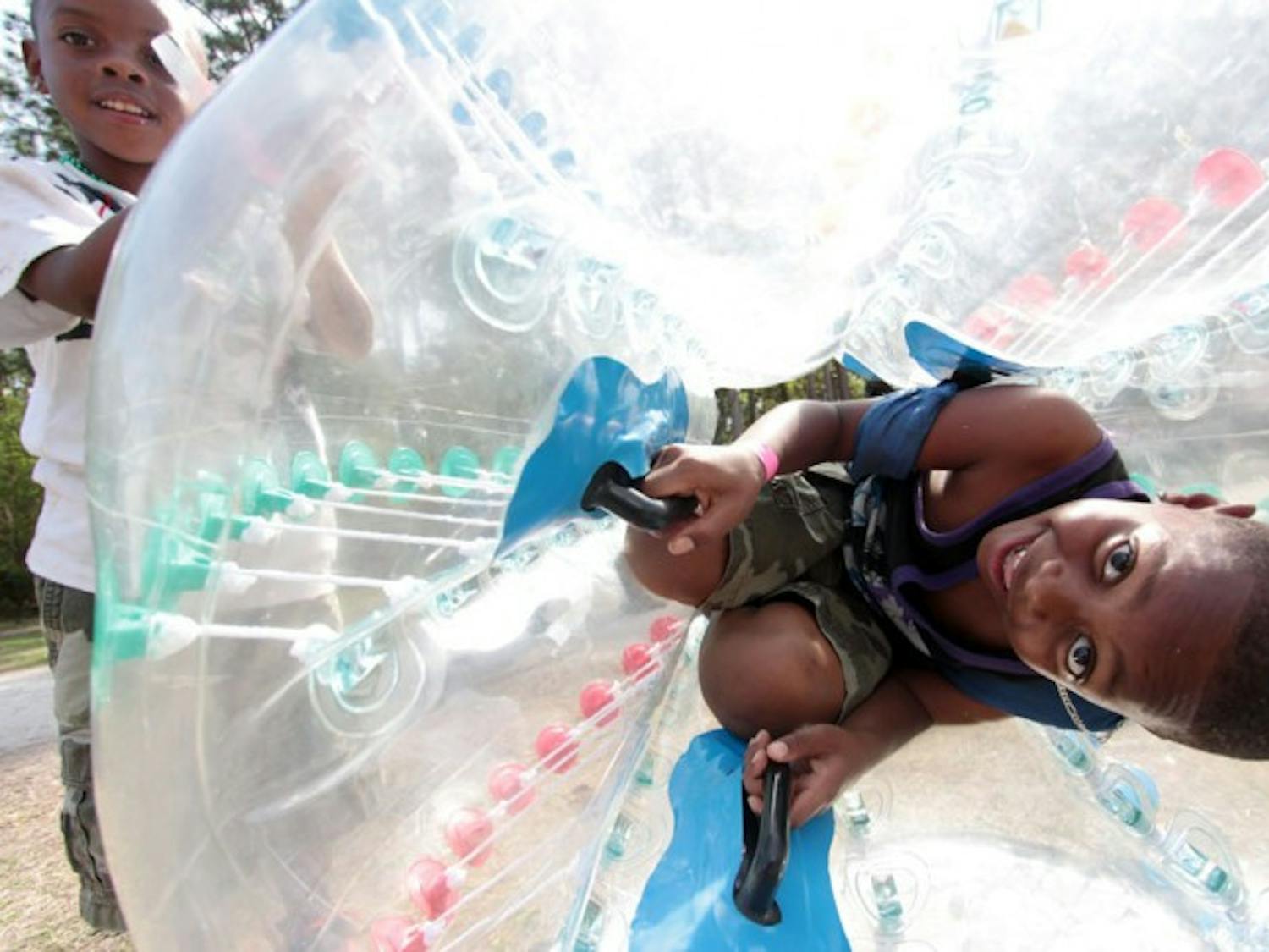 Brothers Murdolph Jones, 7, and Malaqhi Jones, 5, play in bumper balls at the Gainesville Community Fest on Saturday afternoon.