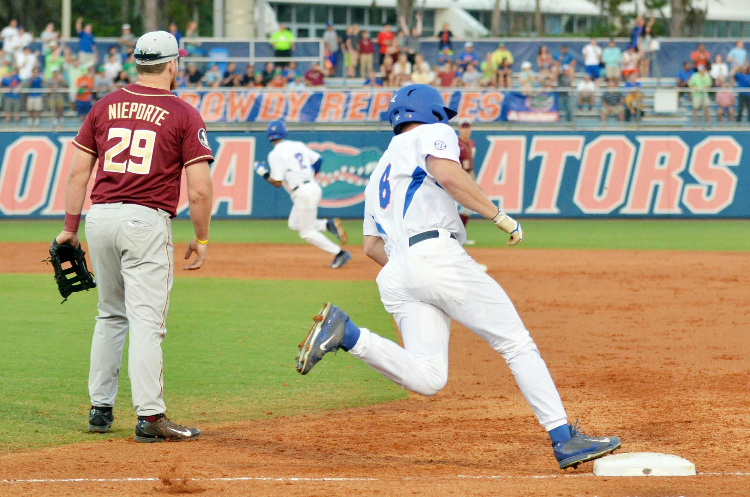 Harrison Bader rounds first base after hitting an RBI triple in the first inning of Florida's 14-8 win against Florida State on Tuesday at McKethan Stadium.