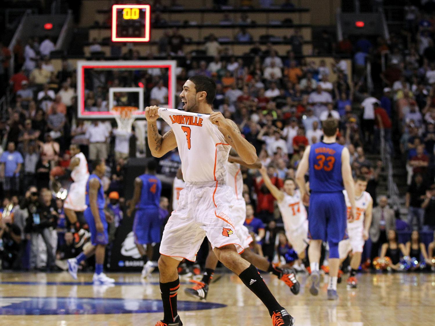 Louisville's Peyton Siva (3) celebrates his team's 72-68 win over Florida in an NCAA tournament West Regional final college basketball game, Saturday, March 24, 2012, in Phoenix. (AP Photo/Chris Carlson)