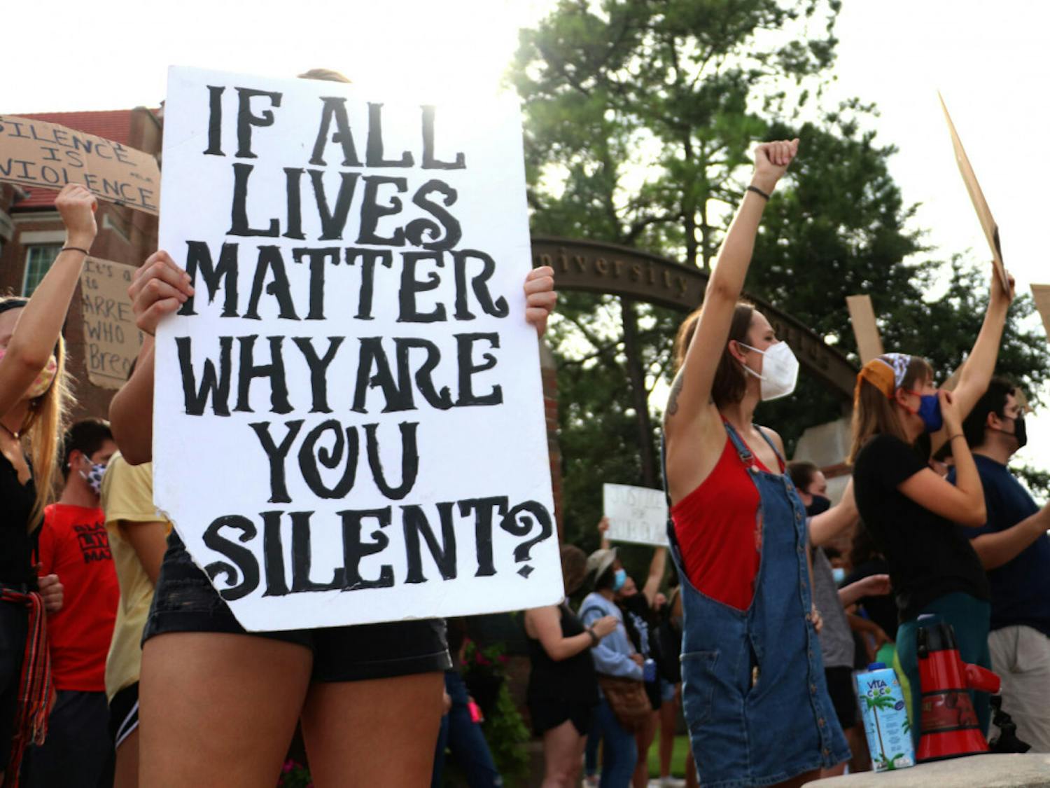 An “If all lives matter why are you silent” sign is held at the protest starting at Heavener of August 28, 2020, in Gainesville, Fla.