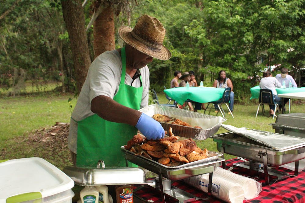 <p>George Foxx helps serve food for the Florida Emancipation Day celebration at the Cotton Club Museum and Cultural Center on Friday, May 20, 2022.</p>