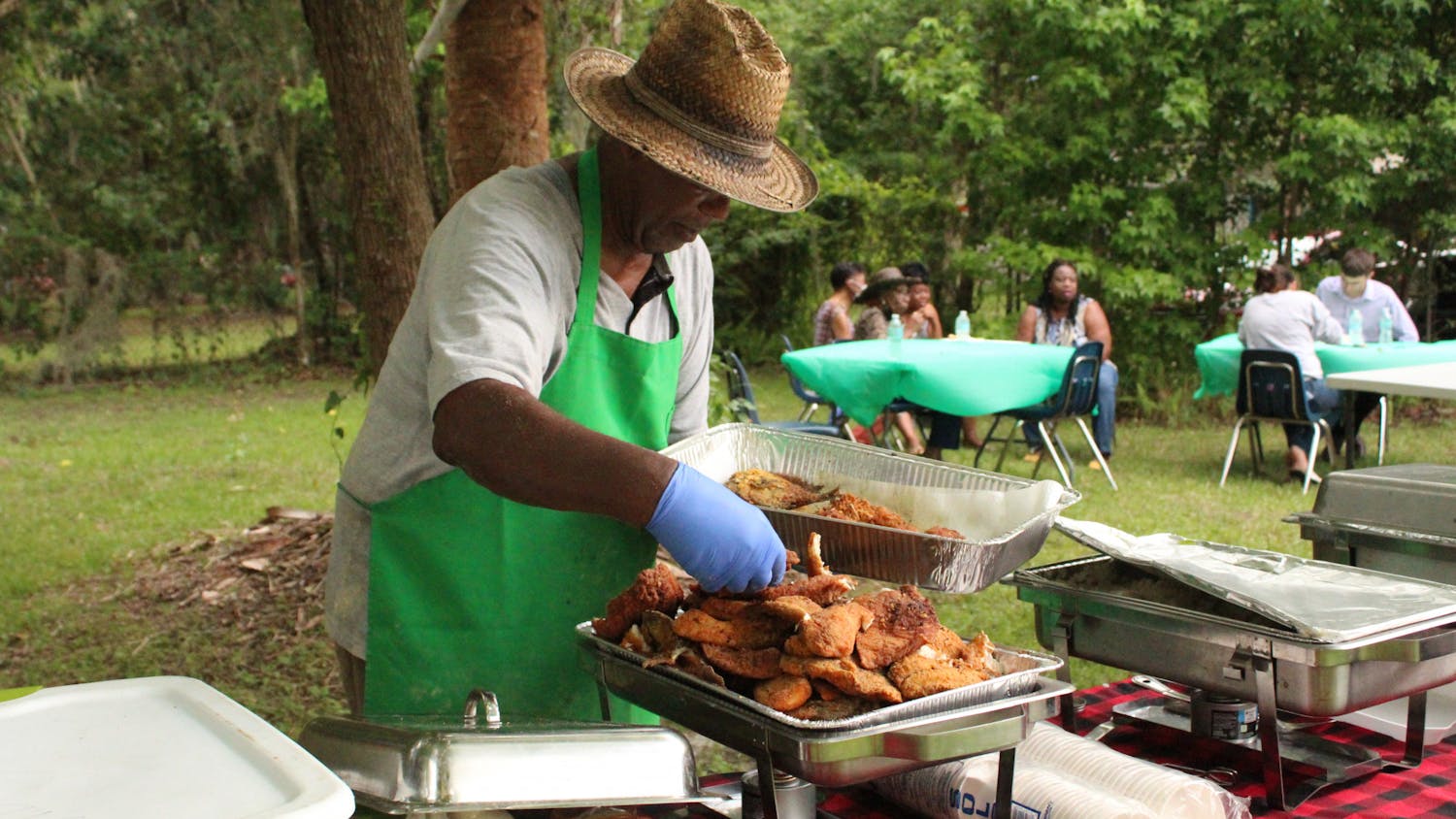 George Foxx helps serve food for the Florida Emancipation Day celebration at the Cotton Club Museum and Cultural Center on Friday, May 20, 2022.