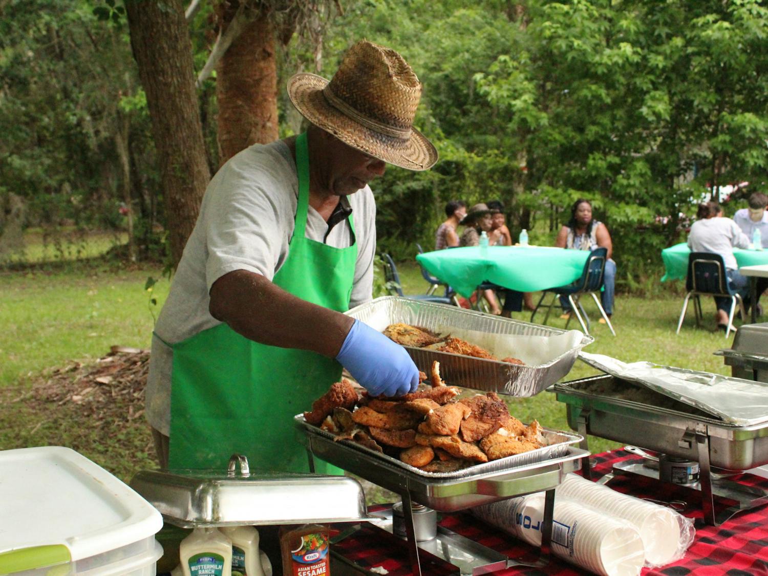 George Foxx helps serve food for the Florida Emancipation Day celebration at the Cotton Club Museum and Cultural Center on Friday, May 20, 2022.