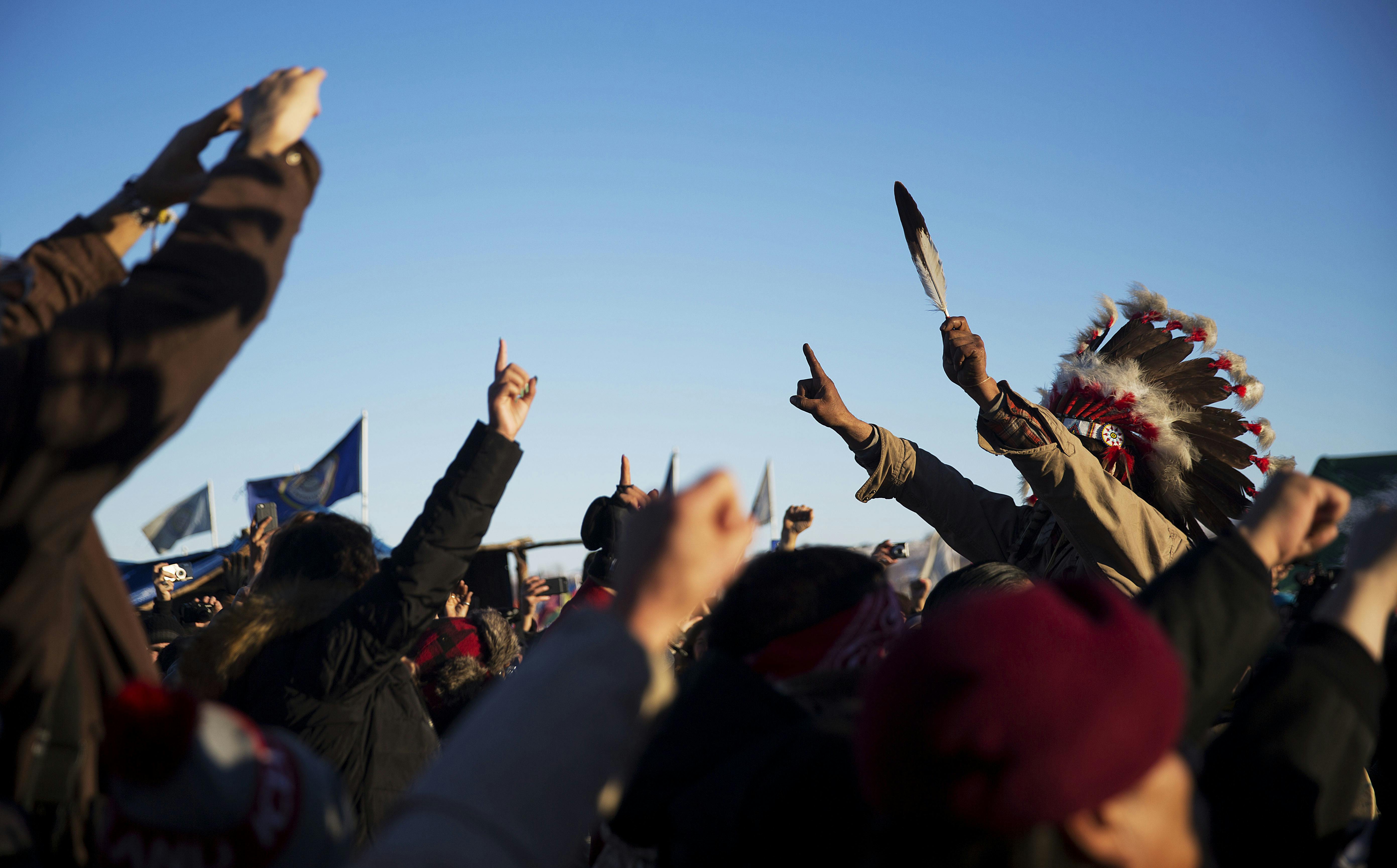 A crowd gathers in celebration at the Oceti Sakowin camp after it was announced that the U.S. Army Corps of Engineers won't grant easement for the Dakota Access oil pipeline in Cannon Ball, N.D., Sunday, Dec. 4, 2016.