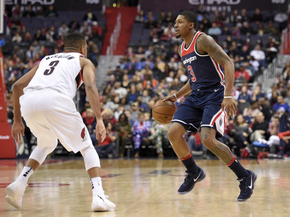 Washington Wizards guard Bradley Beal, right, dribbles against Portland Trail Blazers guard CJ McCollum, left, during the first half of an NBA basketball game, Saturday, Nov. 25, 2017, in Washington. (AP Photo/Nick Wass)