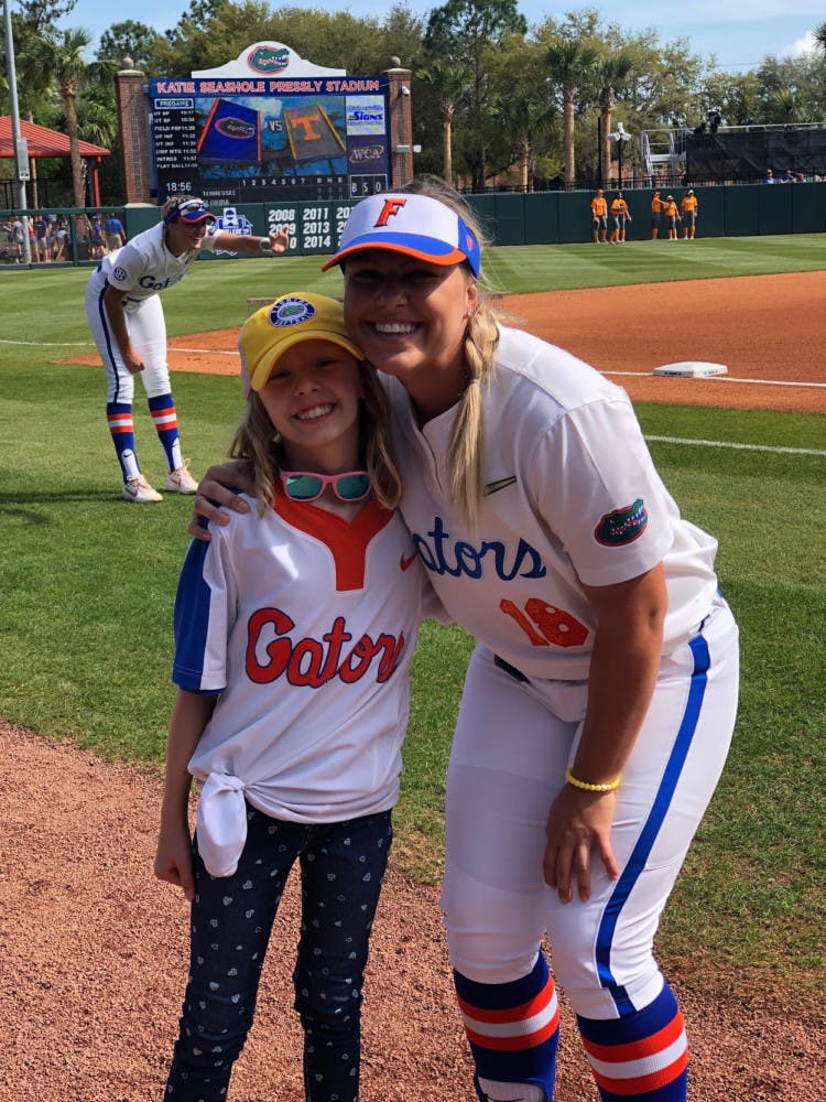 Hartley poses with UF first baseman/left fielder Amanda Lorenz before Florida's game against Tennessee on March 10. The Gators defeated the Volunteers 8-0 with Hartley cheering from the dugout.&nbsp;