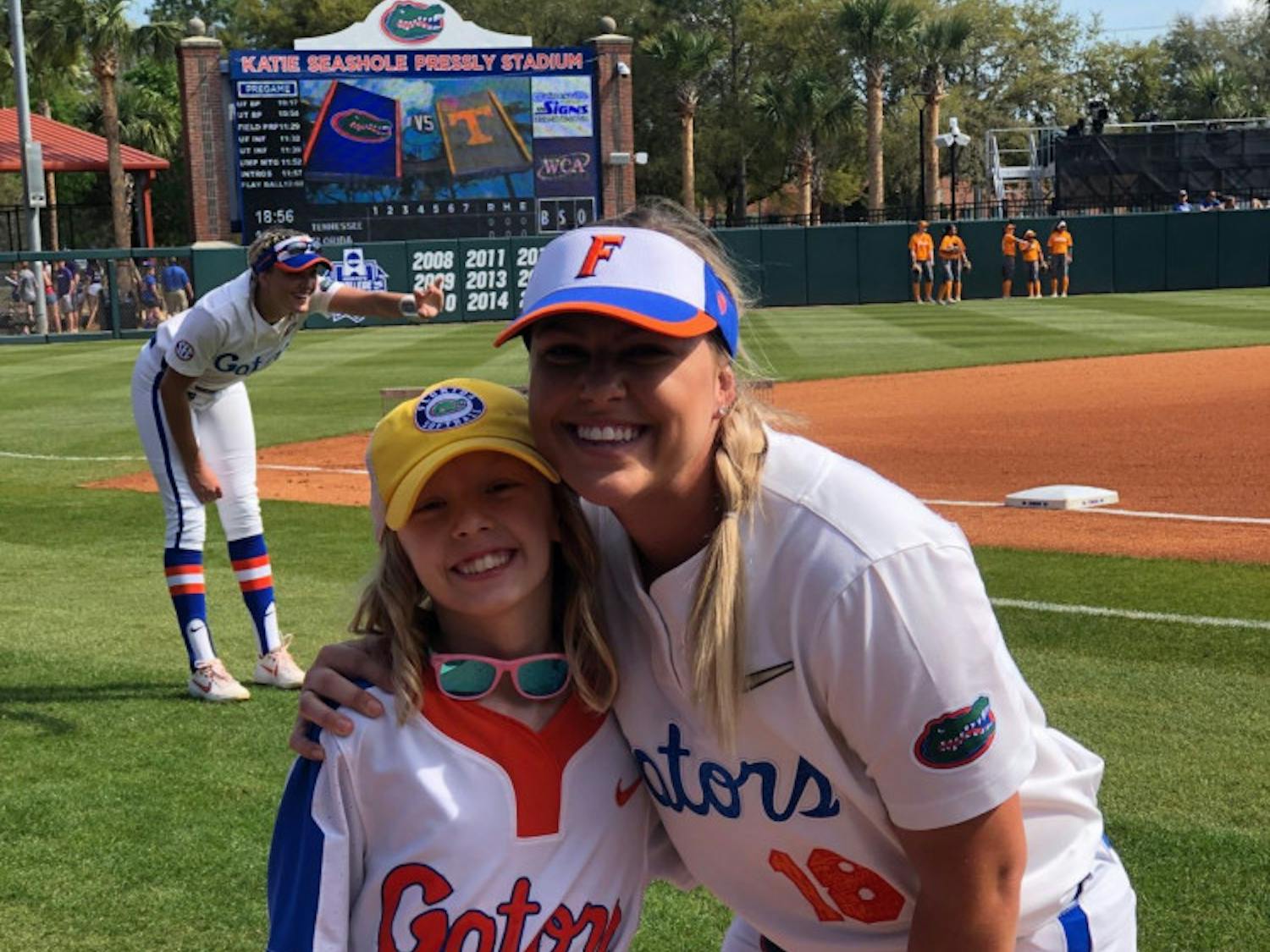 Hartley poses with UF first baseman/left fielder Amanda Lorenz before Florida's game against Tennessee on March 10. The Gators defeated the Volunteers 8-0 with Hartley cheering from the dugout.&nbsp;