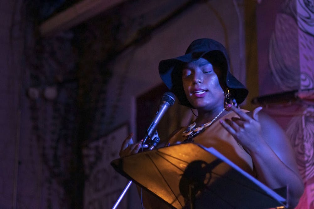 Kayla Rodney performs at the open mic night Sept. 24 at the Civic Media Center. Rodney was the featured artist for the night, which had a theme of Afrofuturism, a genre of media that blends black culture with science fiction and technology.