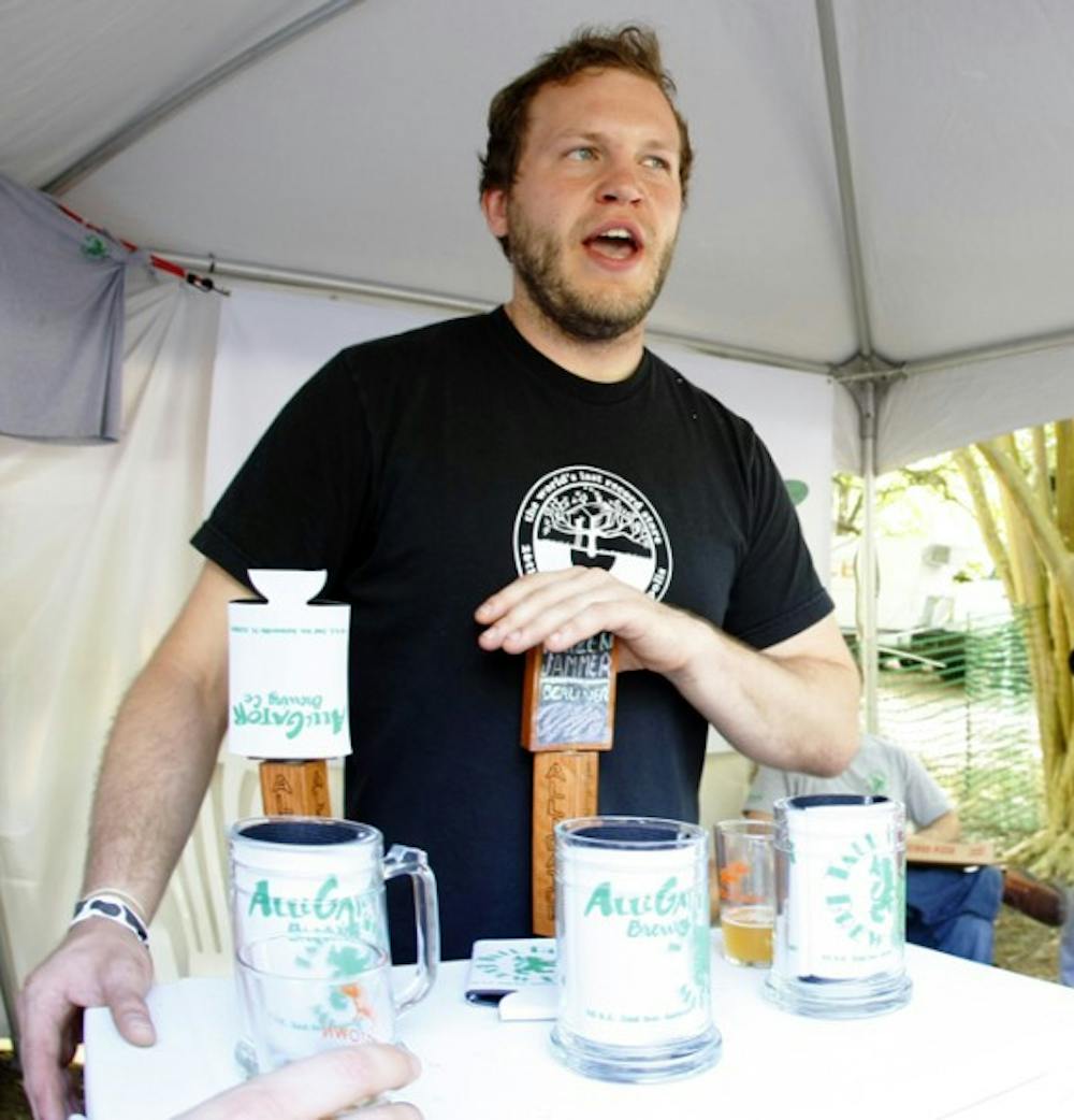 <p>Neal Mackowiak, brewer at Alligator Brewing Co., serves samples at the Hogtown Craft Beer Festival on Saturday.</p>