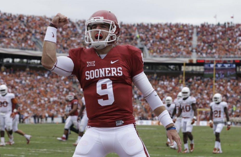 <p>Oklahoma quarterback Trevor Knight (9) celebrates a touchdown by teammate Samaje Perine during the second half of an NCAA college football game against Texas at the Cotton Bowl, Saturday, Oct. 11, 2014, in Dallas.&nbsp;</p>