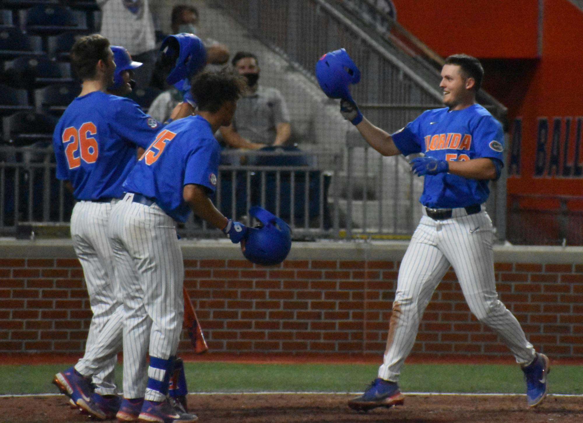 Kirby McMullen (52) celebrates with teammates after he hit a home run against Jacksonville March 13.