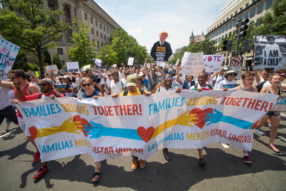 Participants in the Keep Families Together March walk down Pennsylvania Ave on Saturday June 30. Participants marched from Lafayette Square to the National Mall, passing the Department of Justice in the process.