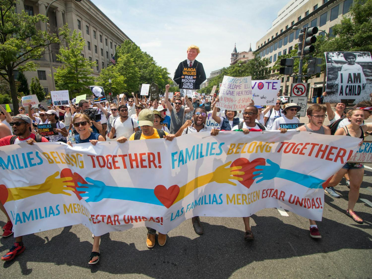 Participants in the Keep Families Together March walk down Pennsylvania Ave on Saturday June 30. Participants marched from Lafayette Square to the National Mall, passing the Department of Justice in the process.