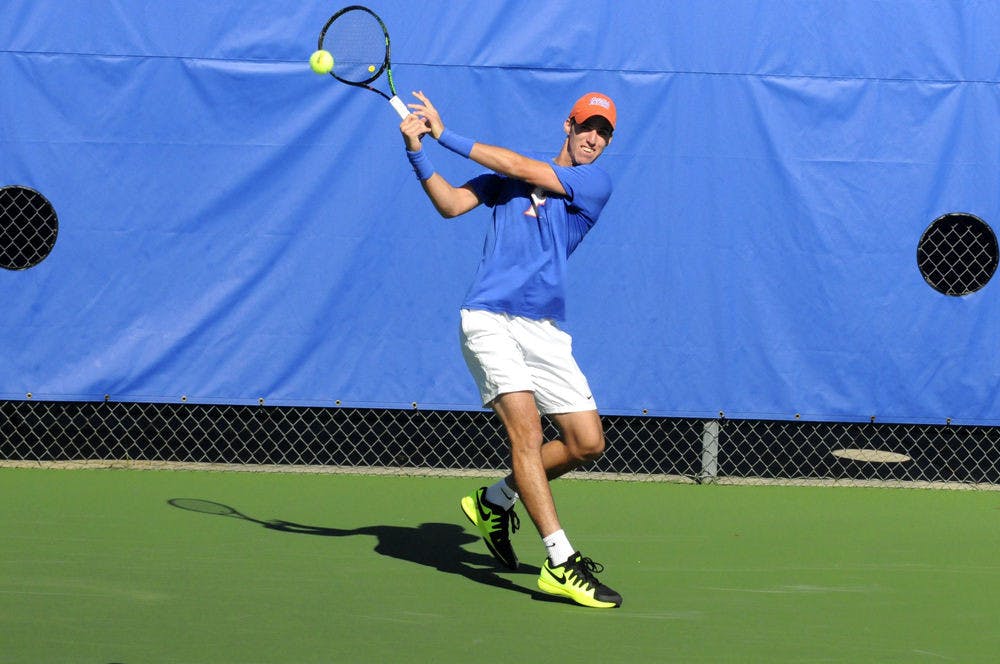 <p>Alfredo Perez returns a ball during Florida's 6-1 win over Troy on Jan. 17, 2016, at the Ring Tennis Complex.</p>