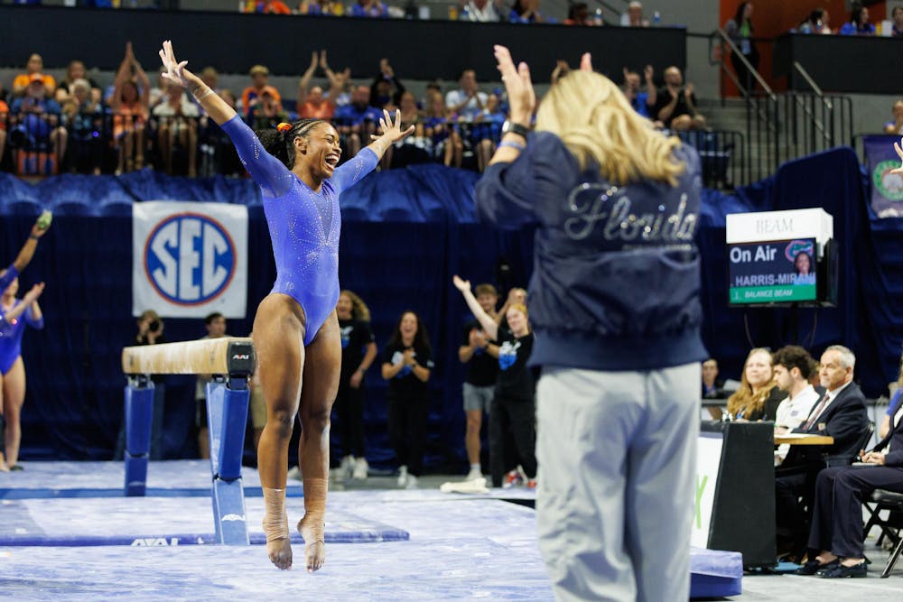 Florida gymnast Selena Harris-Miranda celebrates her balance beam landing during an NCAA gymnastics meet against Louisiana State University, Sunday, March 8, 2026, in Gainesville, Fla.
