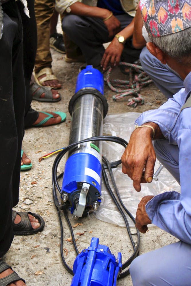 UF’s Engineers without Borders install a new water pump in Nepal during their 2014 trip. This year, the a team of about seven students will return to Nepal to build a hand-washing stations and teach hygiene programs at the local schools.