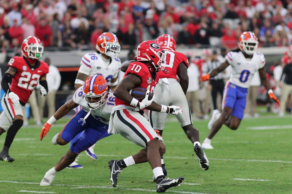 Gators safety Tre'Vez Johnson dives to make a tackle against a Georgia player in Florida's 42-20 loss to the Georgia Bulldogs on Saturday, Oct. 29, 2023.