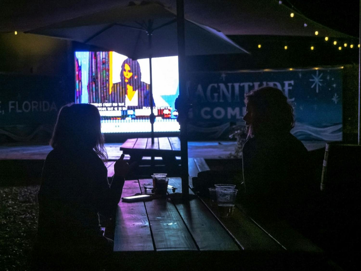 Two women watch the presidential election results at First Magnitude Brewery, located in Gainesville, Fla., on Tuesday, Nov. 3, 2020.