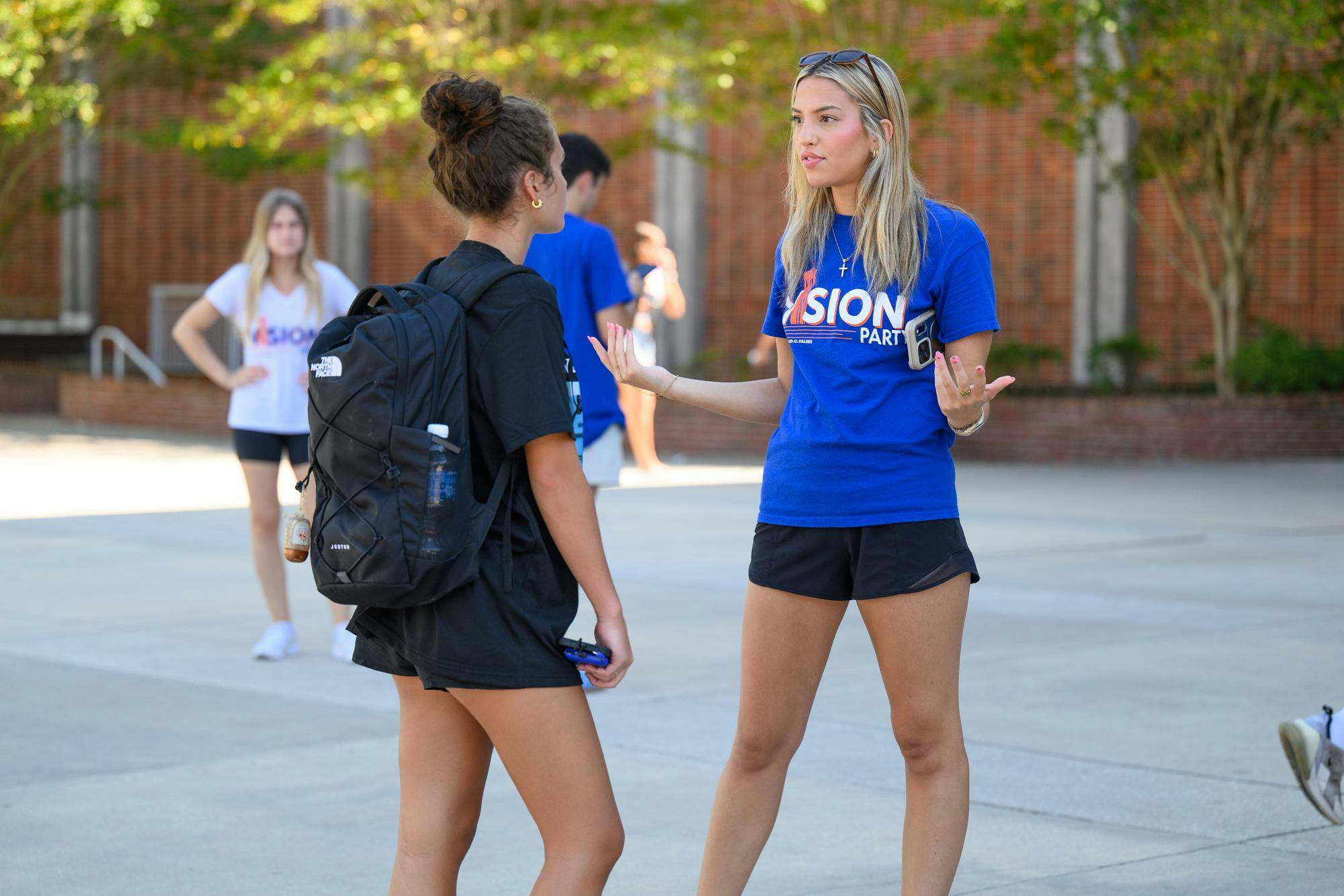 A Vision Party volunteer talks with a student outside the Reitz Union on student government election day, Wednesday, Sept. 30, 2026, in Gainesville, Fla.