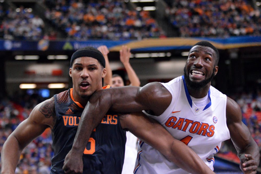 <p>Patric Young (right) boxes out Tennessee's Jarnell Stokes during the Gators' 56-49 win against the Volunteers in the Georgia Dome in Atlanta.</p>