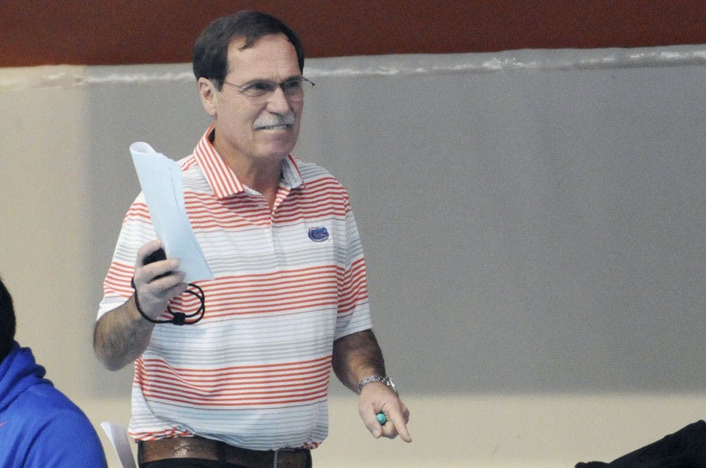 UF coach Gregg Troy encourages his swimmers during Florida’s meet against Auburn on Jan. 23, 2016, in the O’Connell Center.