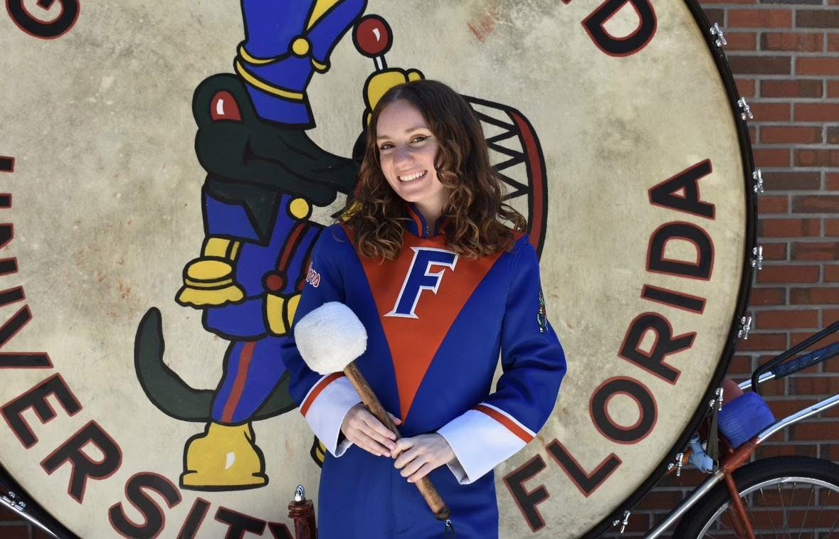 Jillian Colosimo, Gator Band’s first female drumline captain, poses in front of “Big Boom,” the band’s signature bass drum. 