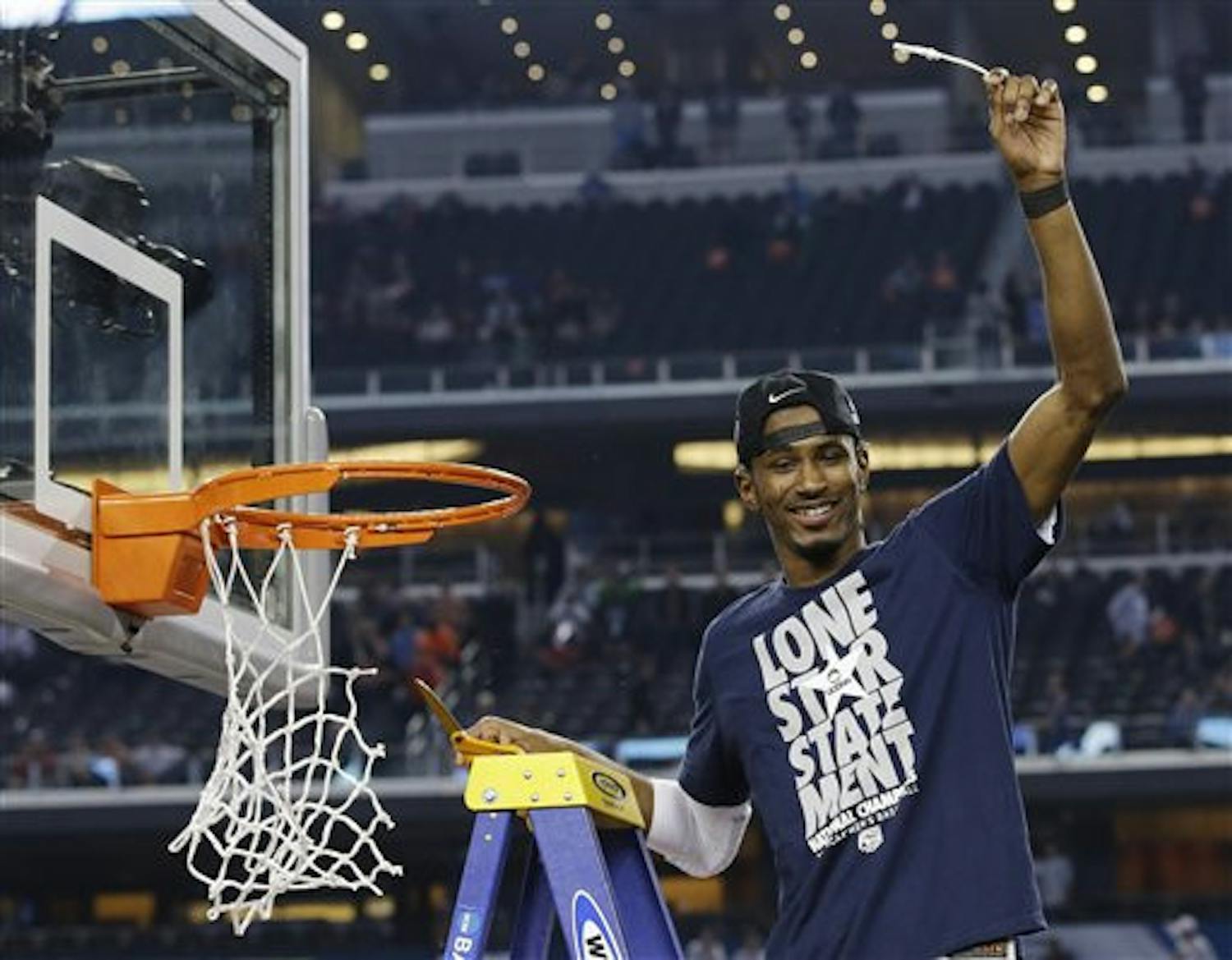 Connecticut guard Lasan Kromah cuts down the net after beating Kentucky 60-54 at the NCAA Tournament championship game Monday in Arlington, Texas.