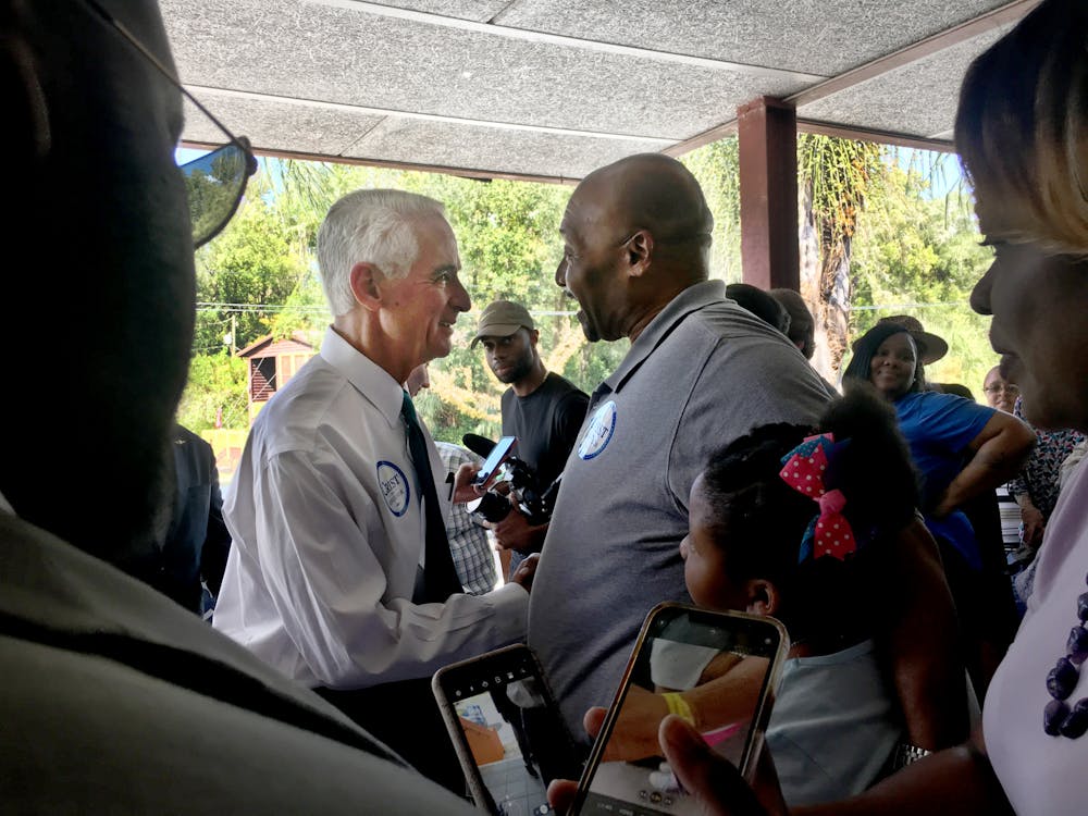 <p>Democratic gubernatorial candidate Charlie Crist greets J.W. Honeysucker, a 58-year-old pastor at Grace United Ministries and Gainesville resident﻿, at a campaign stop at the Alachua County Democratic Headquarters Saturday, Sept. 24, 2022. “I’m supporting him for the stance and the platform he’s running on,” Honeysucker said.</p>