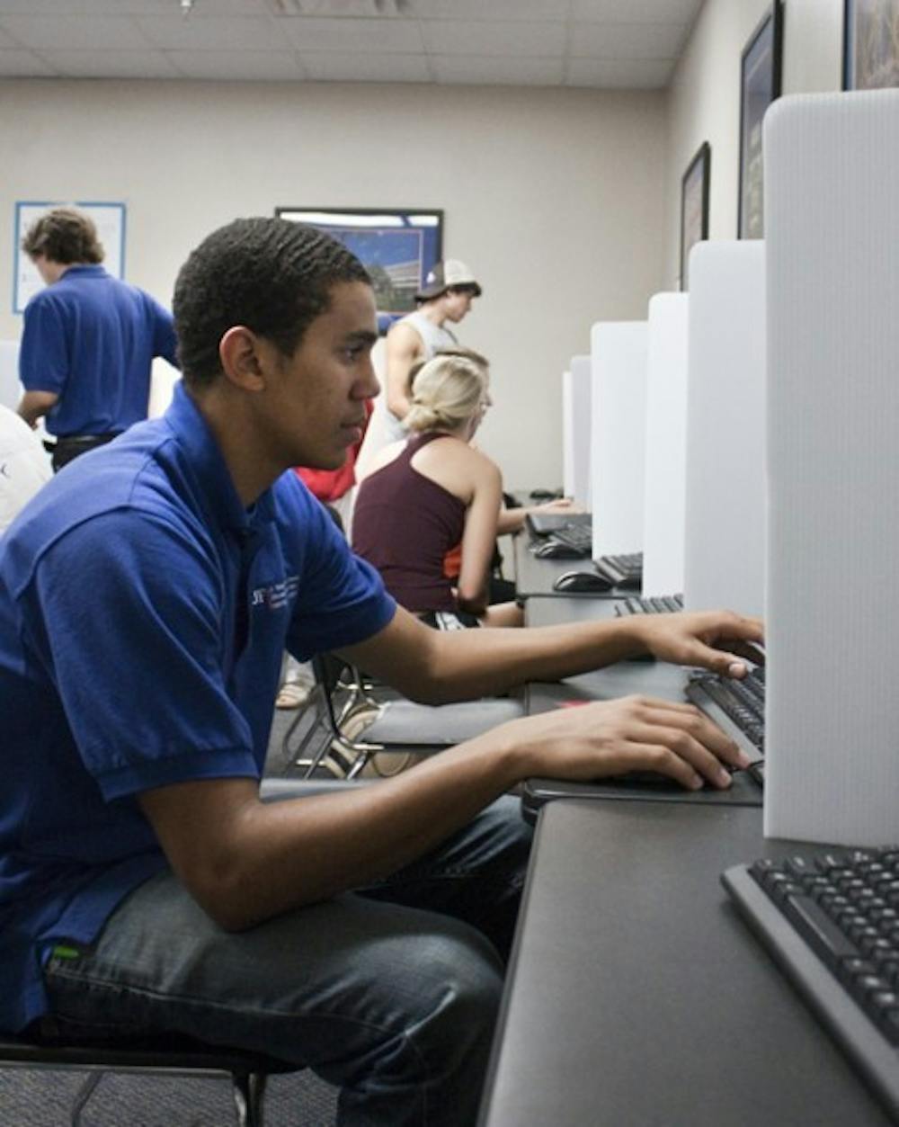 <p>Warren Burgher, 19, a mechanical engineering junior, votes in the Reitz Union computer lab on Sept. 27 for the SG elections.</p>