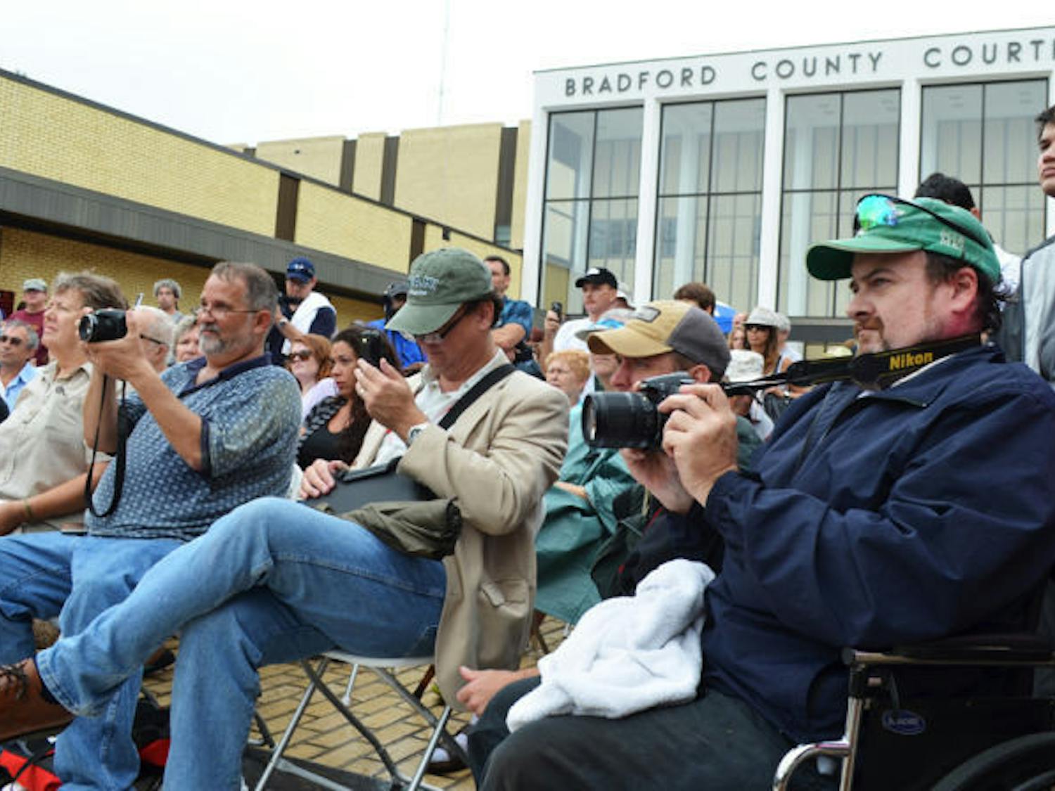 Crowds listen to speakers in front of the Bradford County Courthouse on Saturday, June 29, for the unveiling of an atheist monument near a monument of the Ten Commandments in Starke, Fla.