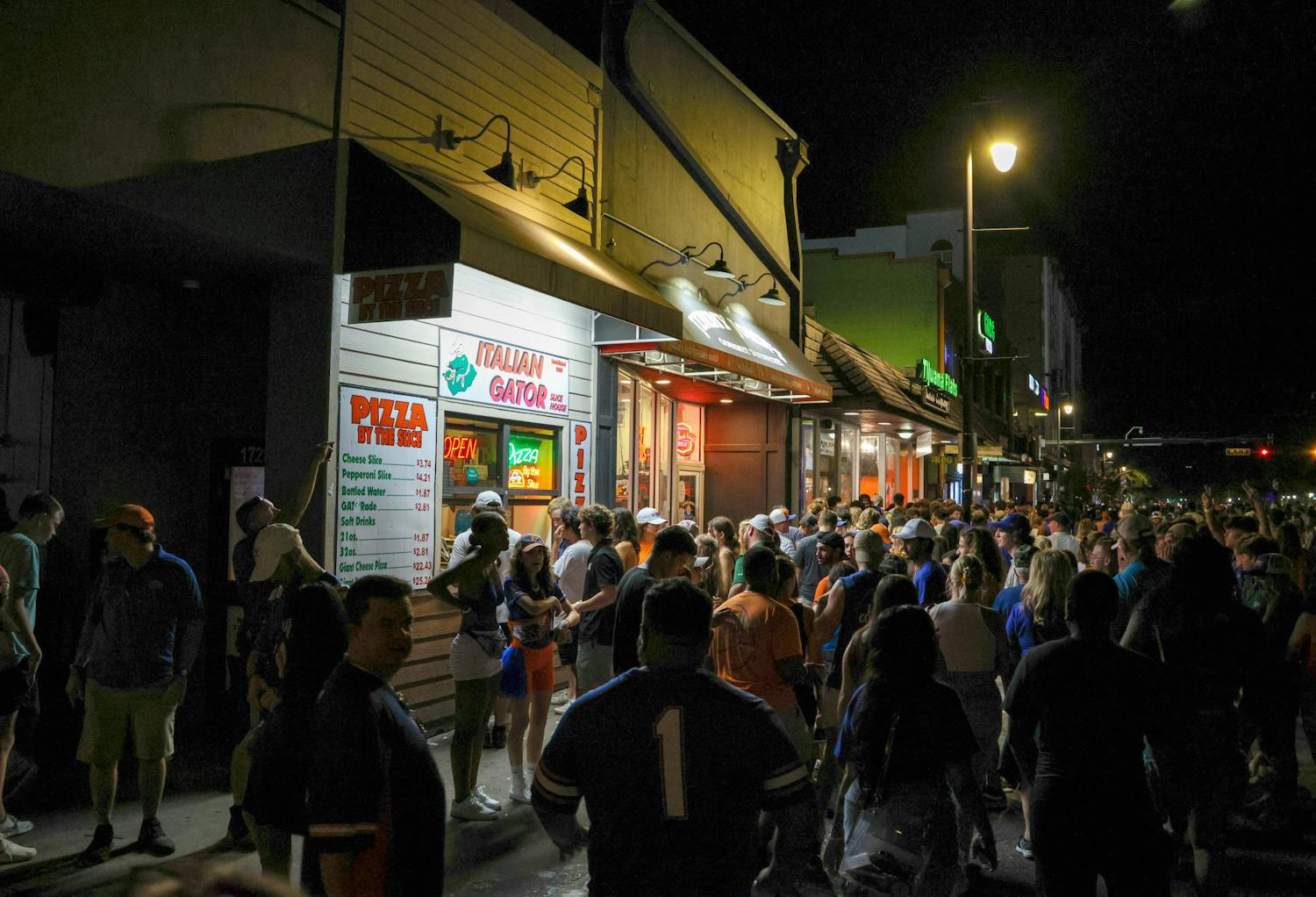 Fans of both Florida and USF wait in line for pizza at Italian Gator following the Gator’s 31-28 win over the Bulls Saturday, Sept 17, 2022.