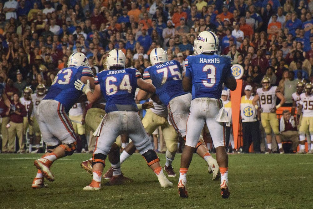 <p>UF offensive linemen Trip Thurman (63), Tyler Jordan (64) and Mason Halter (75) protect quarterback Treon Harris (3) during Florida's 27-2 loss against Florida State on Nov. 28, 2015, at Ben Hill Griffin Stadium.</p>