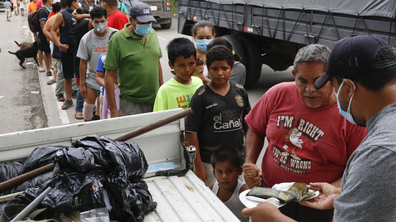 Residents affected by Hurricane Eta stand in a line to receive donated food in Planeta, Honduras, Friday, Nov. 6, 2020. As the remnants of Eta moved back over Caribbean waters, governments in Central America worked to tally the displaced and dead, and recover bodies from landslides and flooding that claimed dozens of lives from Guatemala to Panama.