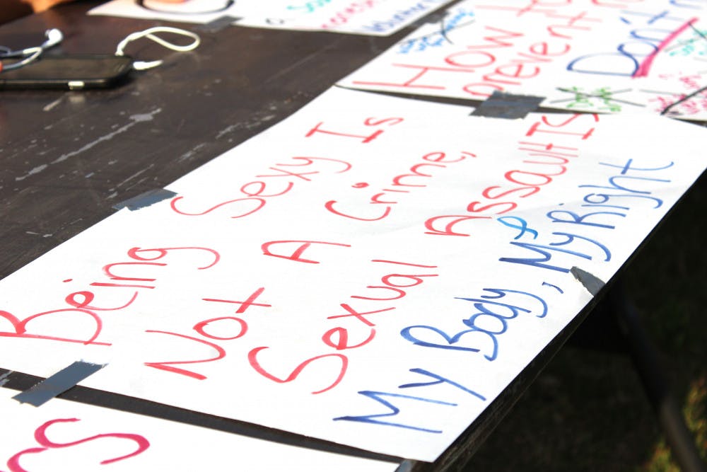 A sign is taped down to a table at the Take Back the Night March and Rally to End Sexual Violence on Wednesday. Attendees at the event could take markers and make their own signs at one of the booths. 
