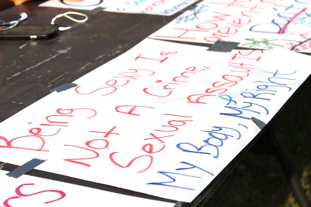 <p dir="ltr"><span>A sign is taped down to a table at the Take Back the Night March and Rally to End Sexual Violence on Wednesday. Attendees at the event could take markers and make their own signs at one of the booths.</span></p><p><span> </span></p>