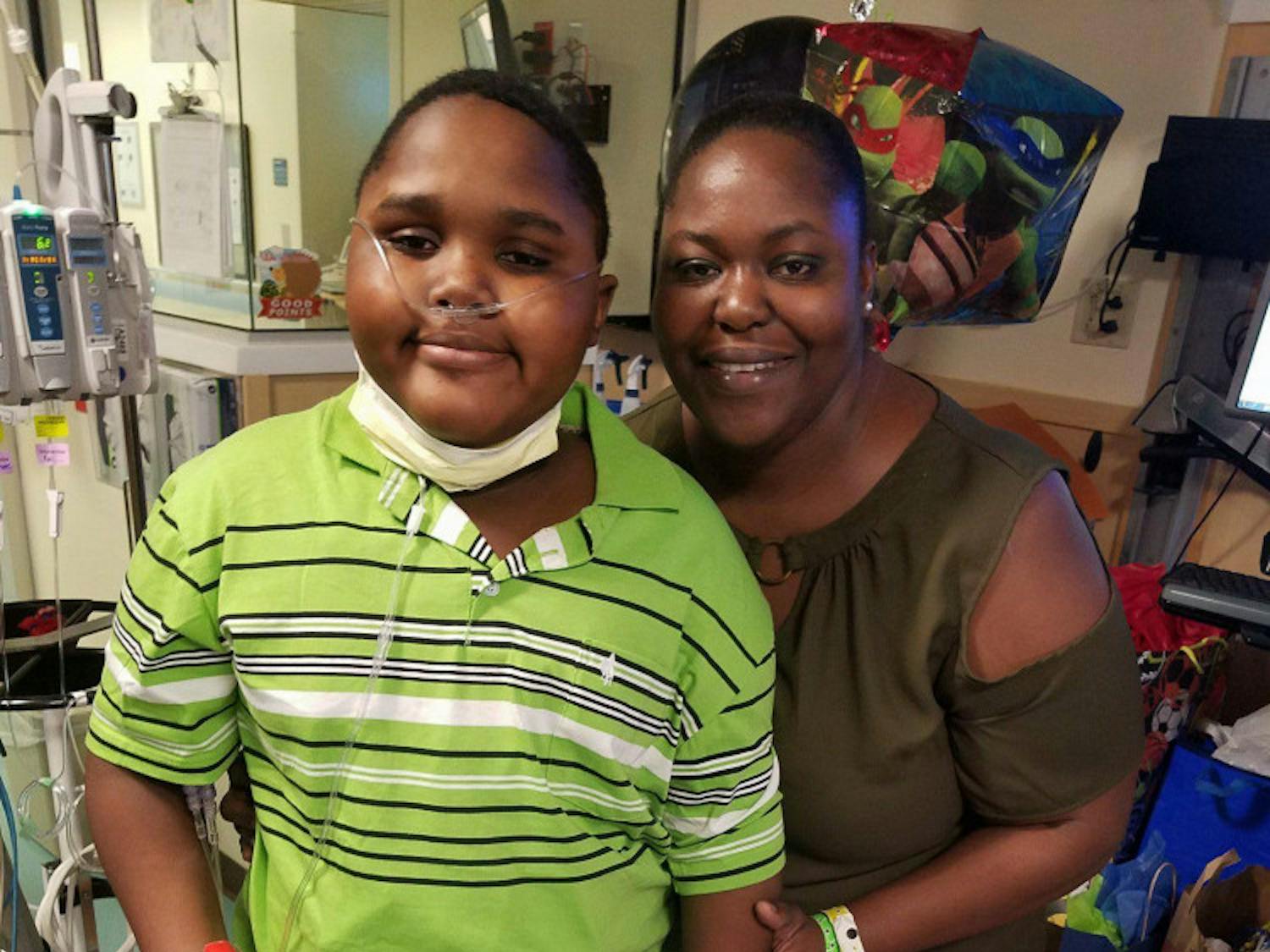 Lowell Thomas and his mother, Malika, celebrate Lowell’s 11th birthday Oct. 30 in the Congenital Heart Center at UF Health Shands Hospital. Lowell, a native of St. Croix, U.S. Virgin Islands, was diagnosed with a fatal heart condition in August while he and Mallika were on vacation in Jacksonville.