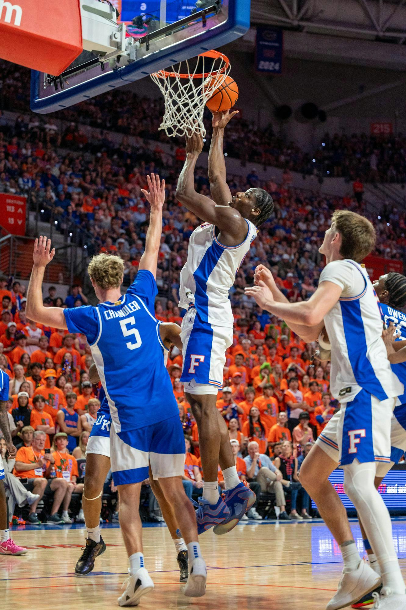 Florida center Rueben Chinyelu (9) lays the ball up against Kentucky guard Collin Chandler (5) during the first half of an NCAA college basketball game, Saturday, Feb. 14, 2026 at Exactech Arena in Gainesville, Fla.