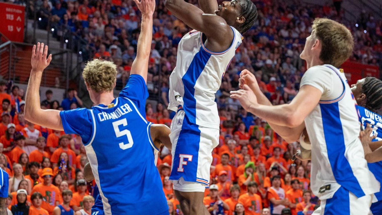 Florida center Rueben Chinyelu (9) lays the ball up against Kentucky guard Collin Chandler (5) during the first half of an NCAA college basketball game, Saturday, Feb. 14, 2026 at Exactech Arena in Gainesville, Fla.