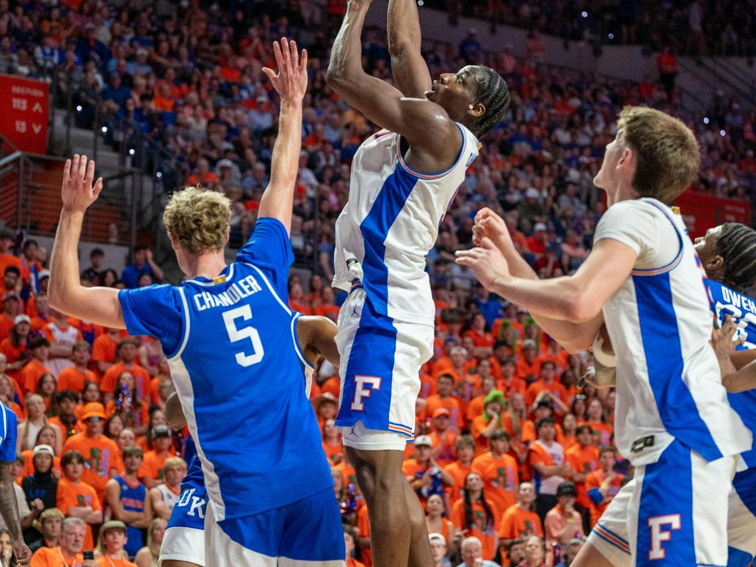 Florida center Rueben Chinyelu (9) lays the ball up against Kentucky guard Collin Chandler (5) during the first half of an NCAA college basketball game, Saturday, Feb. 14, 2026 at Exactech Arena in Gainesville, Fla.