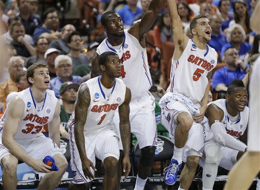 Florida's Erik Murphy (33), Kenny Boynton (1), Patric Young (4), Scottie Wilbekin (5) and Will Yeguete, right, watch on the bench during the final seconds of a second-round game of the NCAA men's college basketball tournament Friday, March 22, 2013, in Austin, Texas. Florida defeated Northwestern State 79-47. (AP Photo/Eric Gay)